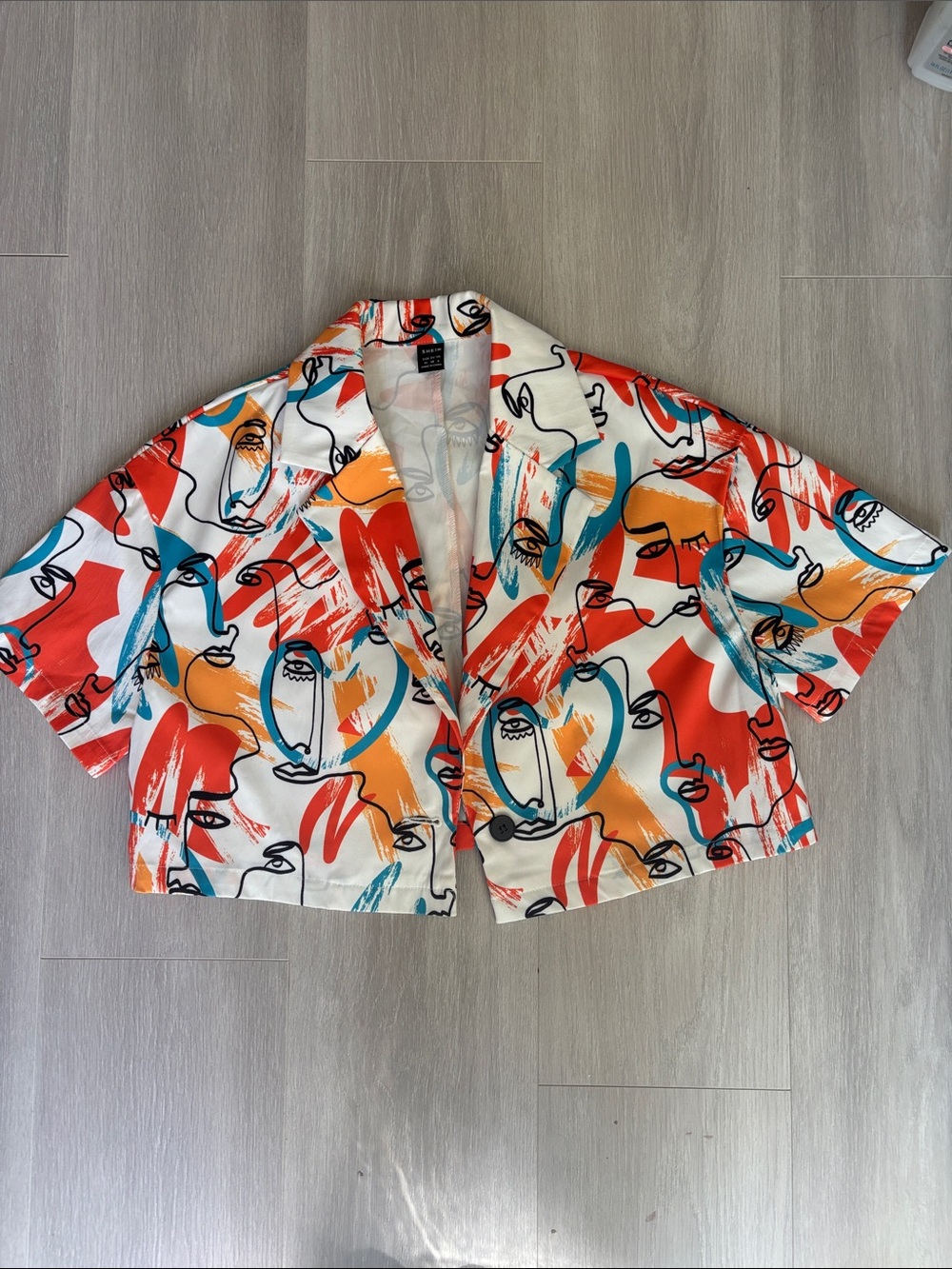 SHEIN White Abstract Face Print Cropped Jacket with Red, Teal & Orange Accents